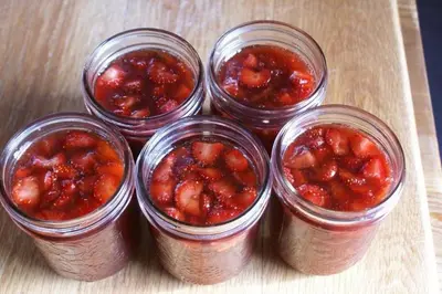 a group of four mason jars filled with strawberry jam at Alpenglow Bed and Breakfast in Kimberley