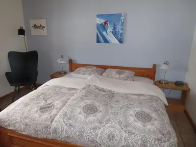 a bedroom with a bed and a desk and a chair at Alpenglow Bed and Breakfast in Kimberley