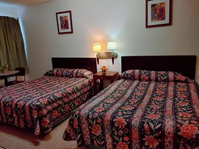 a hotel room with two beds and two lamps at Kootenay Country Inn in Cranbrook