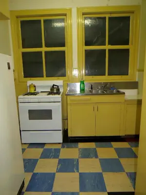 a kitchen with a white stove and a sink at Arundel Mansions Hotel in New Westminster