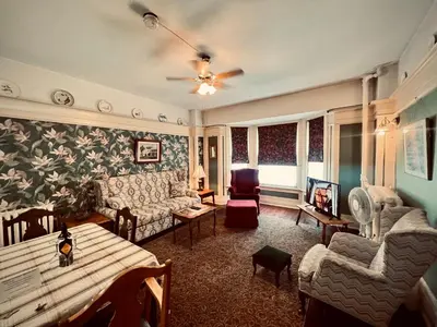 a living room with a couch and a table at Arundel Mansions Hotel in New Westminster