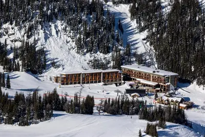 a large building in the snow on a mountain at Sunshine Mountain Lodge in Banff