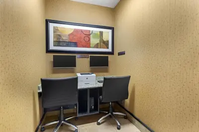 an office with two chairs and a desk with a picture on the wall at Best Western Plus St Albert in St. Albert