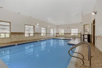 a large swimming pool with blue water at Best Western Wainwright Inn & Suites in Wainwright