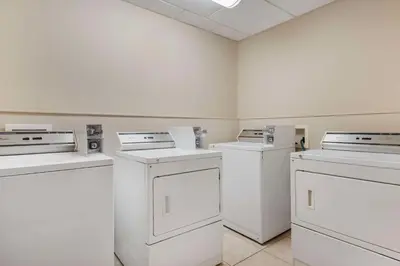a room with four white appliances in a room at Best Western Rocky Mountain House Inn & Suites in Rocky Mountain House