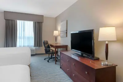 a hotel room with a bed and a flat screen tv at Best Western Rocky Mountain House Inn & Suites in Rocky Mountain House