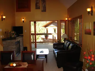 a living room with a couch and a fireplace at Sunshine Coast Resort in Madeira Park