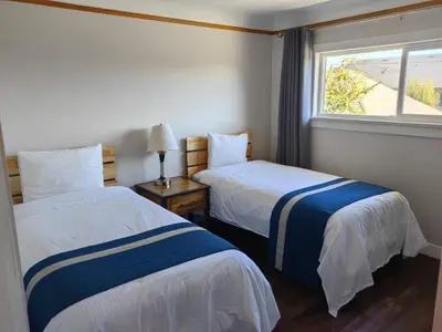 a hotel room with two beds and a window at Harbour Light Motel in Nanaimo