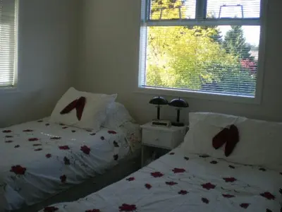 a bedroom with two beds and a window at Island View B&B in Nanaimo