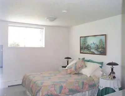 a bedroom with a bed and a window at Island View B&B in Nanaimo