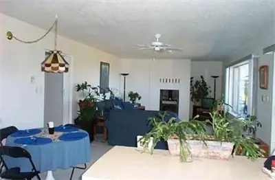 a living room with a blue table and plants at Island View B&B in Nanaimo