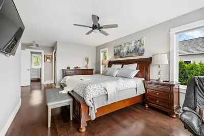 a bedroom with a bed and a ceiling fan at Casa Grande Lakeview House in West Kelowna