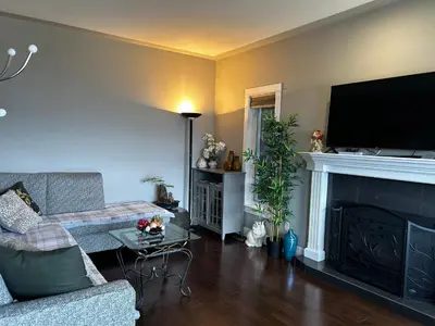 a living room with a couch and a fireplace at Casa Grande Lakeview House in West Kelowna