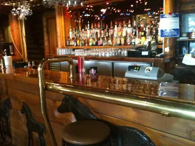 a bar with a counter and some bottles of alcohol at Super 8 by Wyndham Innisfail in Innisfail