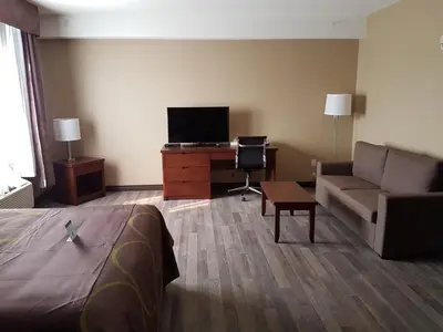 a living room with a couch and a tv at Super 8 by Wyndham Hardisty in Hardisty
