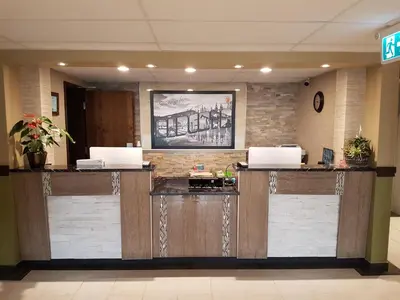 a lobby with two reception desks in a building at Super 8 by Wyndham Hardisty in Hardisty