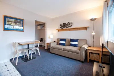 a living room with a couch and a table at Buccaneer Inn in Nanaimo