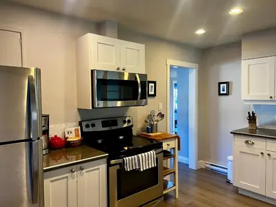 a kitchen with a stove and a microwave at Buccaneer Inn in Nanaimo