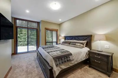 a bedroom with a large bed and a window at 17 Village Walk Sun Peaks BC in Sun Peaks