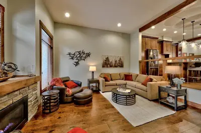 a living room with a couch and a fireplace at 17 Village Walk Sun Peaks BC in Sun Peaks