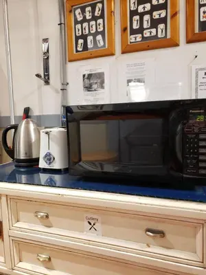 a microwave sitting on top of a kitchen counter at St Clair Hostel in Vancouver