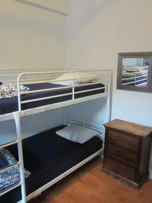 a room with two bunk beds and a table at St Clair Hostel in Vancouver