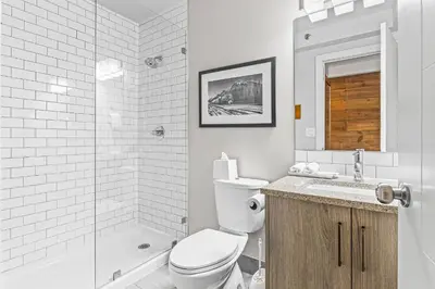 a bathroom with a toilet and a sink and a shower at Basecamp Lodge Canmore in Canmore