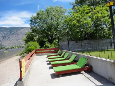 a row of green chairs sitting on a wall at Spanish Fiesta Resort in Osoyoos
