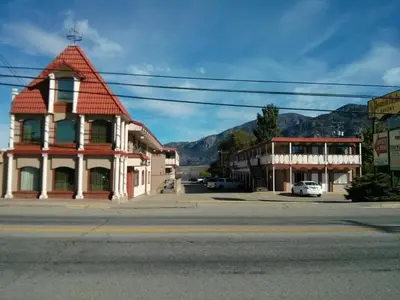 a building on the corner of a street in a town at Spanish Fiesta Resort in Osoyoos