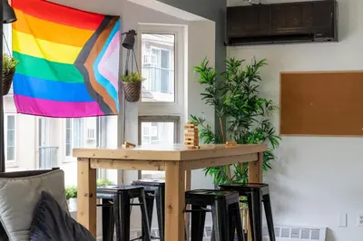 a table with a rainbow flag hanging in a room at Samesun Banff Hostel in Banff