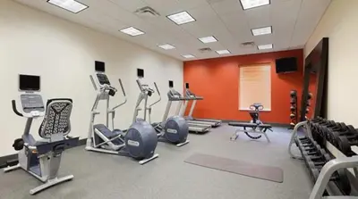 a gym with treadmills and cardio equipment in a room at Hilton Garden Inn Edmonton International Airport in Leduc