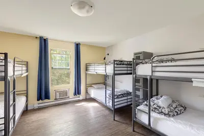 a room with four bunk beds in it at HI Kelowna Hostel in Kelowna