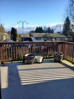 a deck with three pots on a wooden deck at Farhad's B&B in Abbotsford