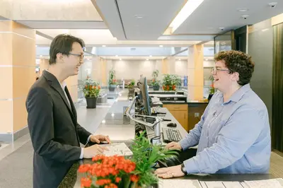 two men standing at a counter in an office at Gage Suites at UBC in Vancouver
