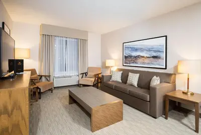 a living room with a couch and a table at Pomeroy Inn & Suites Prince George in Prince George