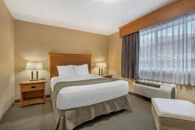 a hotel room with a large bed and a window at Best Western Sicamous Inn in Sicamous