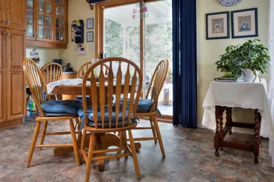 a dining room with a table and chairs and a table at Hummingbird Bed and Breakfast in Clearwater