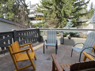 a patio with two chairs and two chairs on a balcony at Buffaloberry Bed & Breakfast in Banff