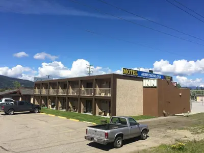 a hotel with a truck parked in front of it at Armstrong Inn in Armstrong