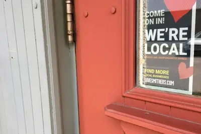 a sign on a door with a were local sign on it at Stork Nest Inn in Smithers