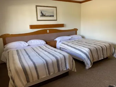 a hotel room with two beds in a room at Stork Nest Inn in Smithers