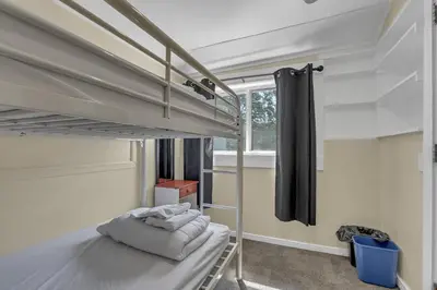 a bedroom with a bunk bed and a window at HI Penticton - Hostel in Penticton