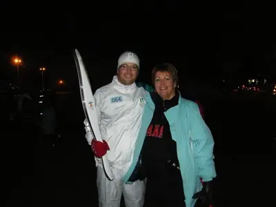 two men standing next to each other holding a pair of skis at Silvern Lake Trail Bed and Breakfast in Smithers