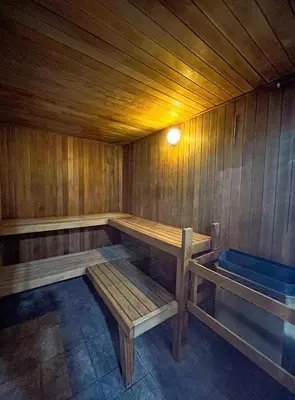 a wooden bench in a sauna with a light at Alpenglow Lodge by MVA in Whistler