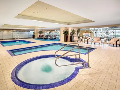 a swimming pool in the middle of a hotel lobby at Fairmont Vancouver Airport In-Terminal Hotel in Richmond