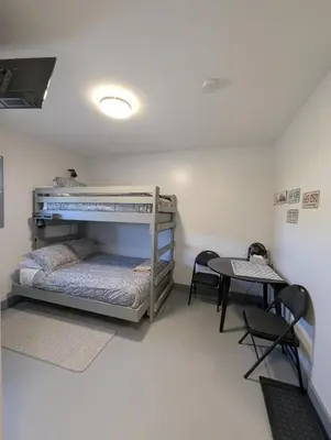 a room with two bunk beds and a table at The Ranch Highway 55 in Debden