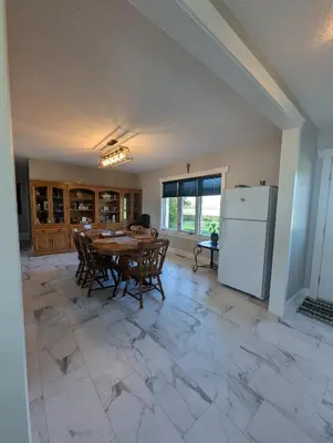 a dining room with a table and a refrigerator at The Ranch Highway 55 in Debden