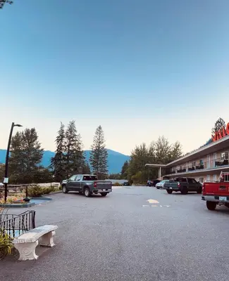 a parking lot with cars parked in front of a motel at Villa Motel in Nelson