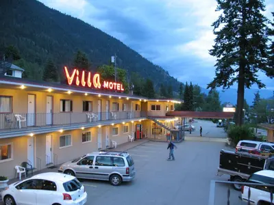 a hotel with cars parked in a parking lot at Villa Motel in Nelson
