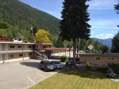 a motel with cars parked in a parking lot at Villa Motel in Nelson